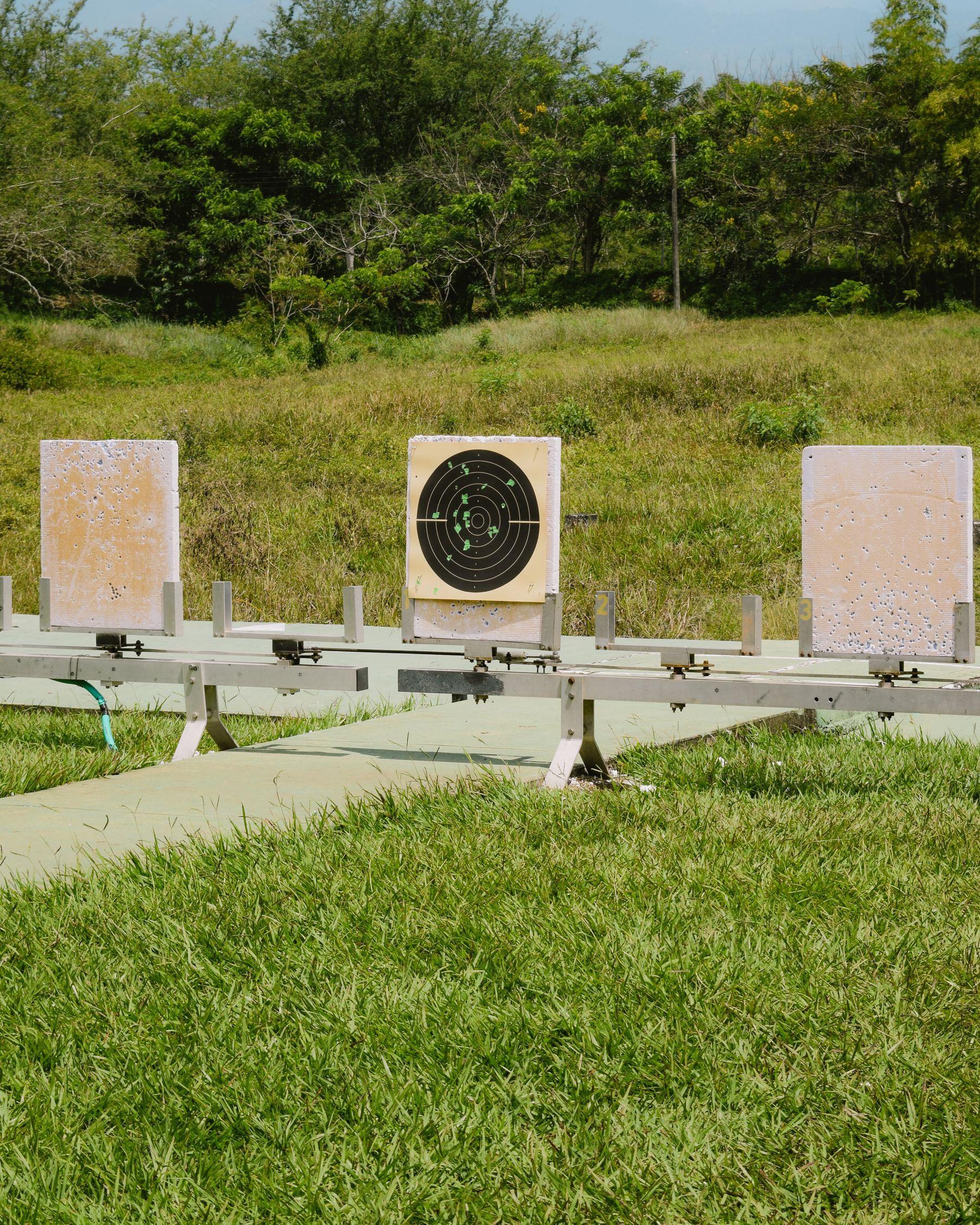 Paper targets on stands at an outdoor shooting range